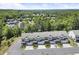 Aerial view of townhomes showcasing a well-maintained community with lush surroundings and convenient parking at 8240 Sonata Ln, Cumming, GA 30041