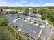 Aerial view of modern townhomes surrounded by lush greenery, offering a serene and well-planned community at 8240 Sonata Ln, Cumming, GA 30041