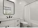 Stylish bathroom with white shiplap walls, subway tile shower, and modern black fixtures at 8240 Sonata Ln, Cumming, GA 30041