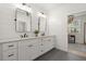 Modern bathroom with double vanity, shaker cabinets, and bright lighting, and dark floors at 8240 Sonata Ln, Cumming, GA 30041