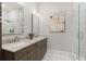 Modern bathroom features double sinks, marble countertops, neutral colors, and a glass shower at 8240 Sonata Ln, Cumming, GA 30041