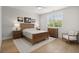 Cozy bedroom with neutral tones, wood accents, and ample natural light from the large window at 8240 Sonata Ln, Cumming, GA 30041