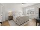 Bright bedroom with hardwood floors, a large bed, and a view of the neighborhood at 8240 Sonata Ln, Cumming, GA 30041