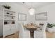 Elegant dining room with a chandelier, modern furnishings, and a display cabinet at 8240 Sonata Ln, Cumming, GA 30041