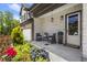 Inviting front porch with seating area and manicured landscaping, offering a warm welcome to the home at 8240 Sonata Ln, Cumming, GA 30041