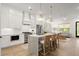 Bright, open kitchen featuring an island with bar seating, stainless steel appliances, and hardwood flooring at 8240 Sonata Ln, Cumming, GA 30041