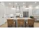 Beautiful kitchen features an island with bar stools and stainless steel appliances at 8240 Sonata Ln, Cumming, GA 30041