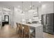 Open-concept kitchen with stainless steel appliances, a large island, and adjacent living spaces at 8240 Sonata Ln, Cumming, GA 30041