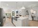 Spacious kitchen with a marble island, stainless steel appliances, and an open layout to the living area at 8240 Sonata Ln, Cumming, GA 30041