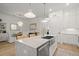 The kitchen features an island with a farm sink with stainless steel appliances at 8240 Sonata Ln, Cumming, GA 30041