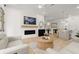 Open-concept living space with a fireplace, modern furnishings, and seamless flow into the dining and kitchen areas at 8240 Sonata Ln, Cumming, GA 30041