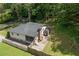 This aerial view shows the home, screened-in porch, the privacy wooden fence, and backyard swing set at 184 Rambo Sw Pl, Marietta, GA 30064
