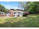 This backyard boasts a home with a brick chimney, an outdoor storage, and well-maintained landscaping at 184 Rambo Sw Pl, Marietta, GA 30064