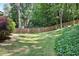 Spacious backyard featuring mature trees, a lush lawn, and a classic wooden fence at 184 Rambo Sw Pl, Marietta, GA 30064