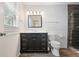 Charming bathroom featuring a dark wood vanity, decorative mirror and a glass shower at 184 Rambo Sw Pl, Marietta, GA 30064