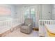 Adorable Bedroom features a glider, neutral rug, and three white cribs at 184 Rambo Sw Pl, Marietta, GA 30064
