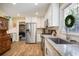 Bright kitchen featuring modern appliances, white cabinets, granite countertops, and a convenient stainless steel refrigerator at 184 Rambo Sw Pl, Marietta, GA 30064