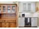 Charming kitchen with white cabinets, granite countertop, beverage cooler, and custom wood details at 184 Rambo Sw Pl, Marietta, GA 30064