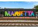 Colorful 'Marietta' mural on the side of a building, adding an artistic flair to the neighborhood's local charm at 184 Rambo Sw Pl, Marietta, GA 30064
