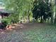 Large backyard surrounded by mature trees, offering a private outdoor space for relaxation and activities at 185 W Lake Nw Dr, Atlanta, GA 30314