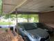 A covered carport with two parked cars and a brick wall at 185 W Lake Nw Dr, Atlanta, GA 30314