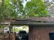 View of the carport showing roof damage and a car parked underneath at 185 W Lake Nw Dr, Atlanta, GA 30314