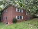Traditional two-story brick home featuring classic architecture and mature trees on a natural landscape at 185 W Lake Nw Dr, Atlanta, GA 30314