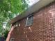 Low angle of home's brick exterior, with windows and trees at 185 W Lake Nw Dr, Atlanta, GA 30314