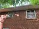 Exterior brick of the home, with trees in the background at 185 W Lake Nw Dr, Atlanta, GA 30314