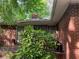 Exterior view of the brick home with window bars and overgrown landscaping at 185 W Lake Nw Dr, Atlanta, GA 30314