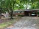 Charming single-story brick home featuring a covered carport and mature trees in a quiet neighborhood at 185 W Lake Nw Dr, Atlanta, GA 30314