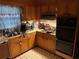 Functional kitchen featuring wood cabinets, tiled floors, and essential appliances, ready for updates at 185 W Lake Nw Dr, Atlanta, GA 30314