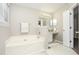 Well-lit bathroom featuring a soaking tub and a vanity with good lighting at 2447 Stancrest Ln, Lawrenceville, GA 30044