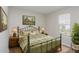 Comfortable bedroom with an iron bed frame, two nightstands, and natural light at 2447 Stancrest Ln, Lawrenceville, GA 30044