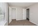 Clean bedroom with neutral walls and carpet, closet and bath access at 2447 Stancrest Ln, Lawrenceville, GA 30044