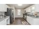 Well-lit kitchen featuring granite countertops, modern stainless appliances, and ample cabinet space at 2447 Stancrest Ln, Lawrenceville, GA 30044