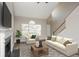 Bright living room with vaulted ceilings, a cozy fireplace, and staircase access at 2447 Stancrest Ln, Lawrenceville, GA 30044