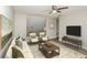 Cozy living room features comfortable seating, a ceiling fan, and a modern television at 2447 Stancrest Ln, Lawrenceville, GA 30044