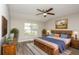 Well-furnished main bedroom with hardwood floors and natural light from a window at 2447 Stancrest Ln, Lawrenceville, GA 30044