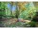 Picturesque backyard with stone pathways, mature trees, and lush greenery, providing a private and serene outdoor space at 5170 Oxbow Rd, Stone Mountain, GA 30087