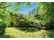 Lush backyard with a well-manicured lawn, mature trees, and greenery, creating a peaceful outdoor space at 5170 Oxbow Rd, Stone Mountain, GA 30087