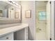 Bright bathroom featuring a vanity area, large mirror, drawers, and a separate toilet at 5170 Oxbow Rd, Stone Mountain, GA 30087