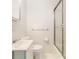 Neat bathroom featuring a vanity, toilet, and shower/tub combo with glass doors, all in a clean white finish at 5170 Oxbow Rd, Stone Mountain, GA 30087
