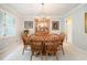 Elegant dining room with a wooden table, six chairs, a chandelier, and bright windows at 5170 Oxbow Rd, Stone Mountain, GA 30087