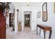 Inviting entryway showcases a tiled floor, white walls, and an elegant table with a mirror above it at 5170 Oxbow Rd, Stone Mountain, GA 30087