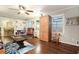 Bright living room featuring hardwood floors, large windows, built in shelving, and access to the dining room at 5170 Oxbow Rd, Stone Mountain, GA 30087