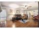 Cozy living room features hardwood floors, a leather sofa, and an open layout to the kitchen at 5170 Oxbow Rd, Stone Mountain, GA 30087