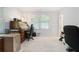 Office space featuring natural light, shutters, a desk, and rolling chair at 5170 Oxbow Rd, Stone Mountain, GA 30087