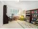 Well lit office space with bookshelves, a desk, a window, and an area rug at 5170 Oxbow Rd, Stone Mountain, GA 30087