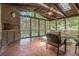 Relaxing screened sunroom with terracotta floors, wood paneling and trim, and peaceful views at 5170 Oxbow Rd, Stone Mountain, GA 30087